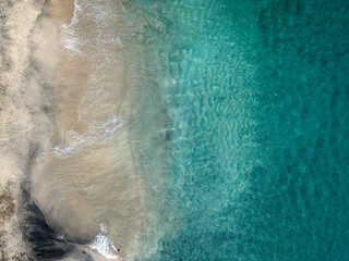Aerial view of White Sand Virgin Beach, blue sea, coastline and mountain. Bali, Indonesia.