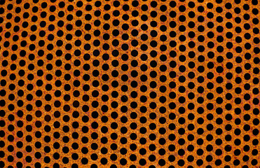 Perforated rusty iron sheet texture. Surface of industrial mesh. Horizontal corrosion steel. Top view