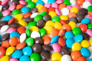Round, multi-colored, chocolates. A pile of multicolored candies