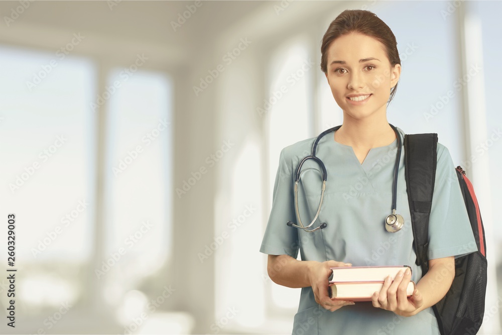 Wall mural attractive young female doctor student on background