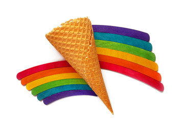 Waffle cone for ice cream, wooden sticks, rainbow color. Selective focus.