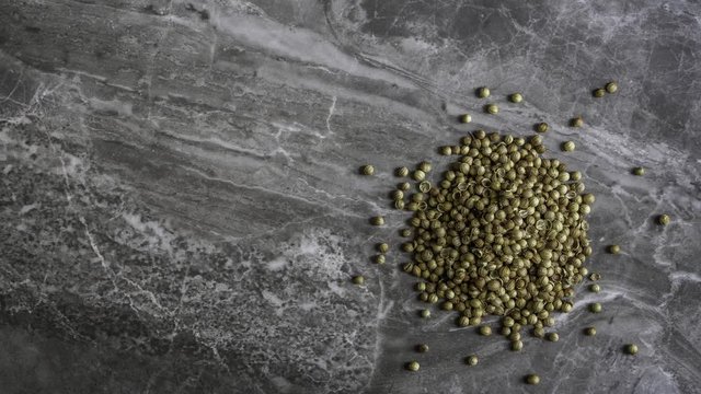 Organic Coriander Seeds on a marble stone background