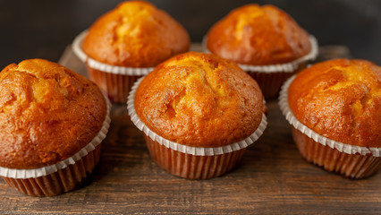 muffins with filling on a cutting board, against the background of dark concrete