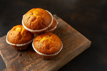 muffins with filling on a cutting board, against the background of dark concrete