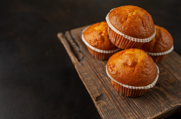 muffins with filling on a cutting board, against the background of dark concrete