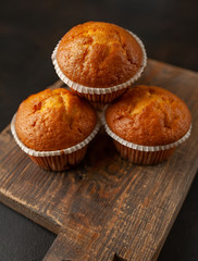 muffins with filling on a cutting board, against the background of dark concrete