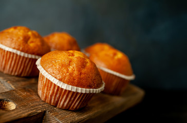 muffins with filling on a cutting board, against the background of dark concrete