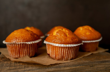 muffins with filling on a cutting board, against the background of dark concrete