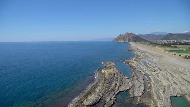 Antalya, Turkey - March 2019: Natural rock formations at Koru beach with people by the mediterranean sea, Gazipasa, Antalya province in Turkey