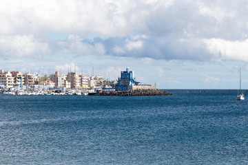 Blue harbormaster house restaurant and view over the beautiful sunny harbour of Marina del Sur in...