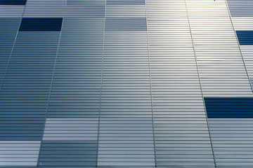 Abstract architectural background from modern buildings facade with blue and silver lines - image