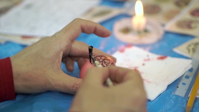 Woman painting easter eggs for holiday, easter preparation concept. cloce up