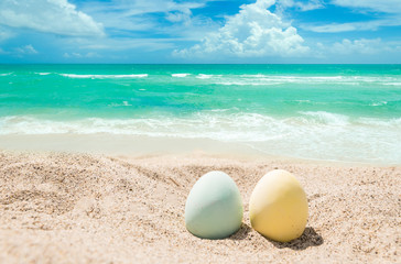 Happy easter lettering background with eggs on the sandy beach - 260332836