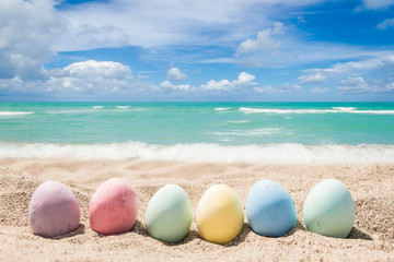 Happy easter lettering background with eggs on the sandy beach - 260333420