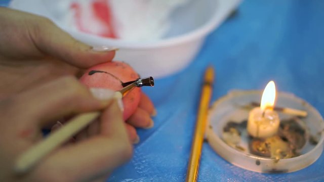 Woman painting easter eggs for holiday, easter preparation concept. cloce up