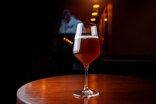 Tall tulip glass full in the bar