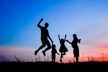Fototapeta na wymiar Happy family playing on nature summer silhouette