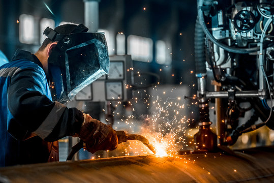 man welds at the factory