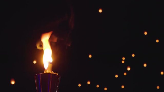 Close up of a tiki torch at night.