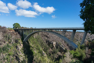 Arch bridge, road above the canyon landscape