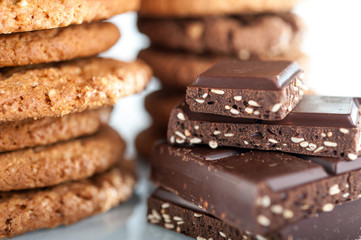 Various shortbread, oat cookies, chocolate chip biscuit and pieces of chocolate with seeds and nuts.