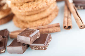 Various shortbread, oat cookies, chocolate chip biscuit and pieces of chocolate with seeds and nuts.
