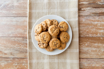 food, junk-food and eating concept - close up of oatmeal cookies with chocolate chips on plate