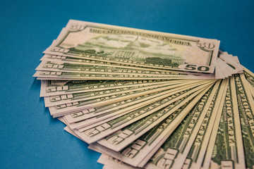 Large Fat Money Roll Isolated on a blue Background.