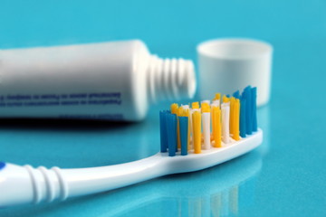 Toothpaste and toothbrush lie on a blue background