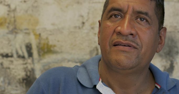 Mexican man looking around and shifting his eyes back and forth