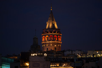 Fototapeta na wymiar Illuminated Galata Tower in Istanbul, Turkey with dark blue sky at the background