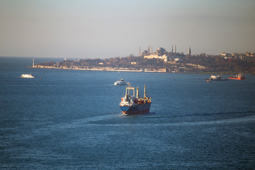 Aerial view of a ship passing by Yavuz Sultan Selim Bridge and Bosphorus