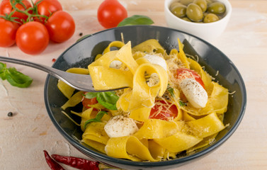 Yellow italian pasta pappardelle, fettuccine or tagliatelle