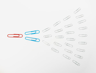 Note paper clips on light background top view