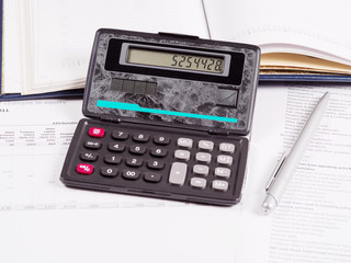 Calculator and financial documents on the table - 260341664