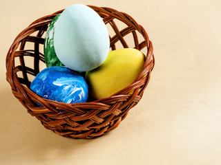 Basket with dyed Easter eggs on a light background