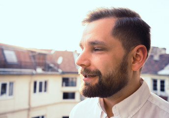 bearded man having a conversation talking in the sunset and white shirt