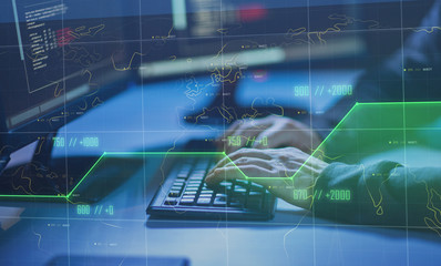 cybercrime, hacking and technology concept - hands of hacker in dark room writing code or using computer virus program for cyber attack