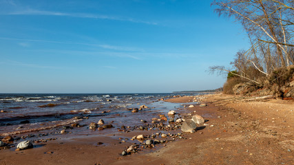 empty sea beach with ice leftovers and no snow