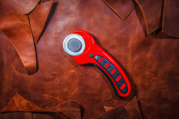 Tool for working with leather. Leather knife. Copy Space. Close-up. Leather background.