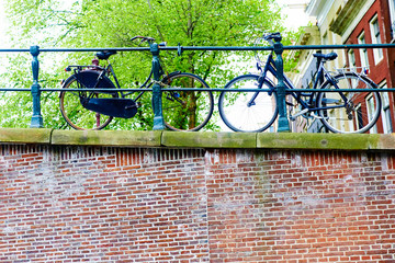 Bicycles parked on street in Amsterdam in rainy day, The Netherlands