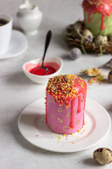 Carrot cake or traditional Orthodox Easter sweet bread with carrot covered pink glaze. Carrot Kulich  decorated with pink glaze.