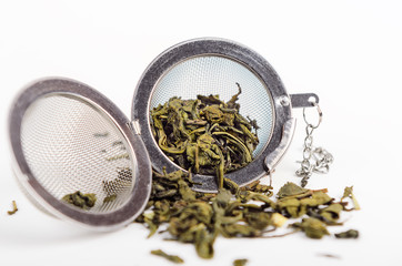 Green tea in a metal strainer. Concept natural tasty healthy drink.