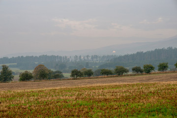 cloudy and foggy sunrise over slovakian landscape in autumn
