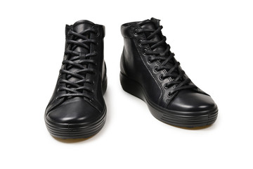 Men's black leather shoes and a black camera on a isolated on white background. Copy space.