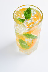 Cocktail with lemon and mint on a white background. Copy space.