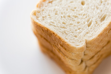 food, junk-food and unhealthy eating concept - close up of white toast bread
