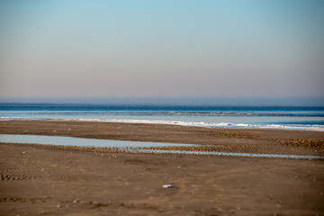 frozen sea beach in winter with low snow coverage