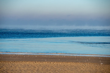 frozen sea beach in winter with low snow coverage