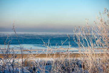 frozen sea beach in winter with low snow coverage